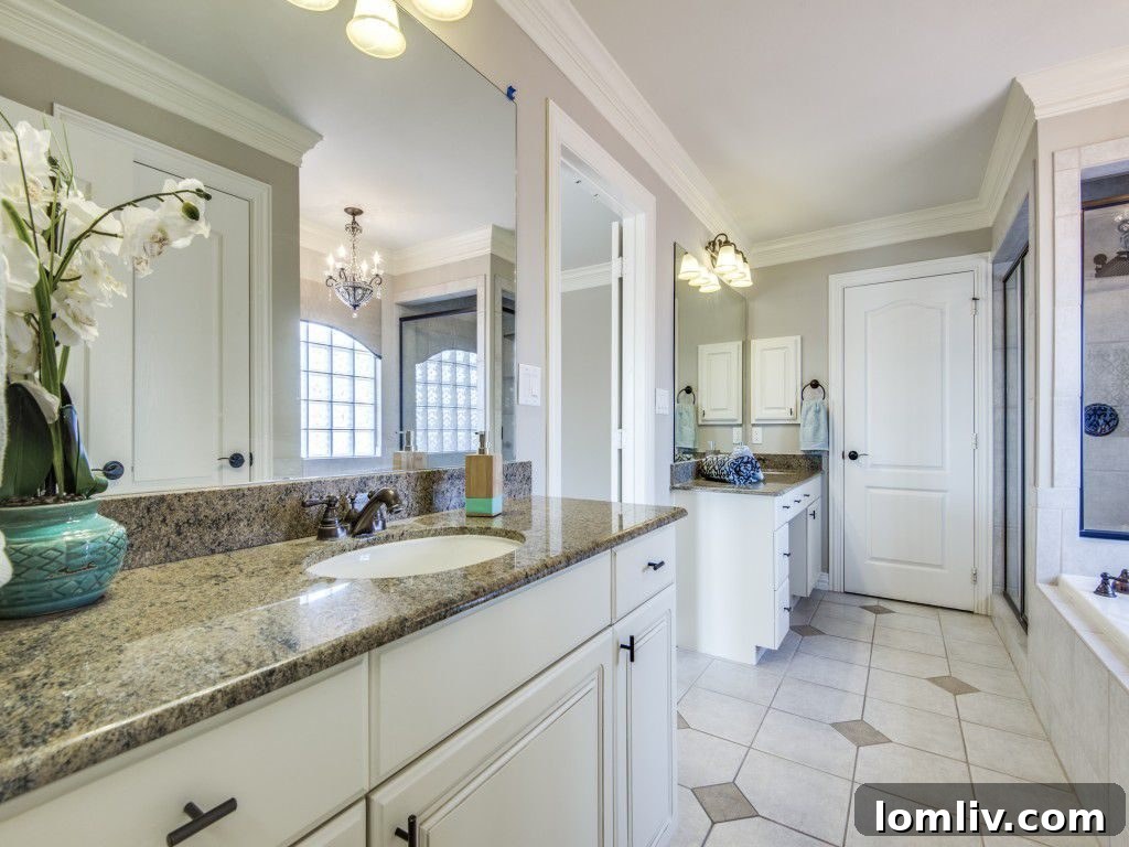 Luxurious Master Bathroom with Double Vanities, Soaking Tub, and Glass Shower