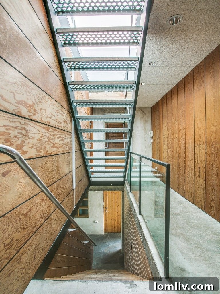 A stylish, architecturally significant staircase connecting the multiple levels of this University Park contemporary home, acting as a sculptural element.
