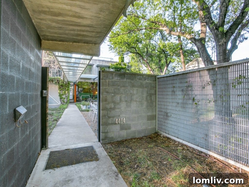 A unique architectural detail shot of 4404 Greenbrier, highlighting the tilt-up concrete walls, textured facade, and modern window design.