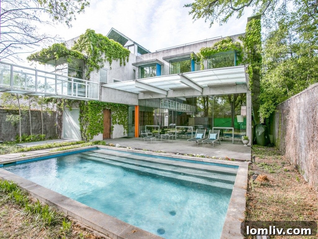 Interior view showcasing the minimalist aesthetic, raw concrete finishes, and abundant natural light inside 4404 Greenbrier Drive.