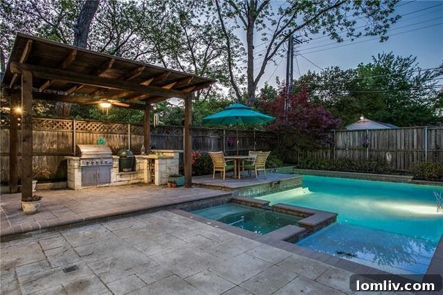 Luxurious master bedroom featuring a cozy fireplace and direct views of the serene backyard pool