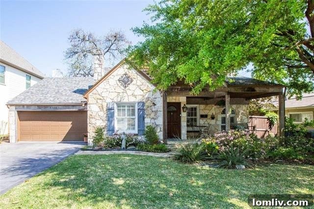 Charming Austin stone Tudor home with a covered front porch and classic architectural details in Wilshire Heights