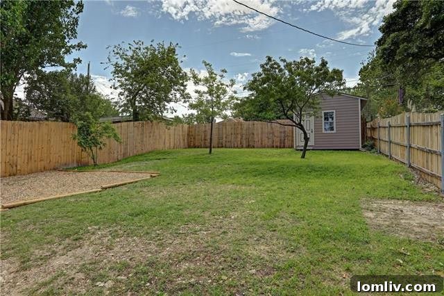 Rear view of the Irwindell cottage, highlighting the spacious backyard and the newly installed roof.