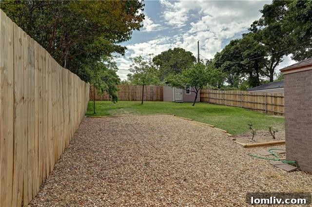 Side view of the home showing the mature trees and the peaceful, green surroundings of the Dells District.