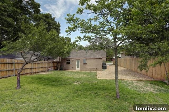 Another angle of the backyard, showcasing its potential for landscaping and creation of personalized outdoor zones.