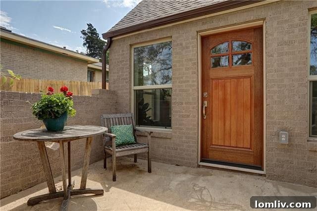 Fully redesigned kitchen with large-format tile flooring, sleek granite countertops, white cabinetry, and stainless steel appliances including a gas range.
