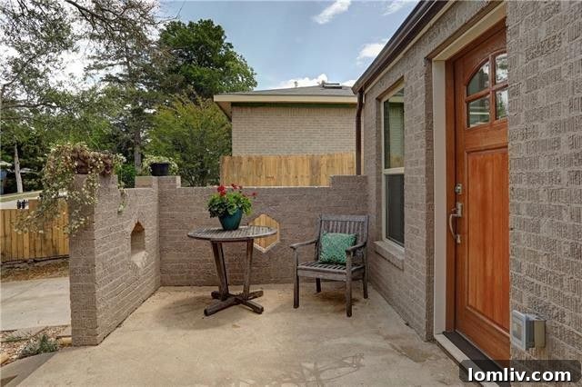 Modern kitchen workspace showcasing stainless steel appliances, ample storage, and abundant natural light from strategic window placement.