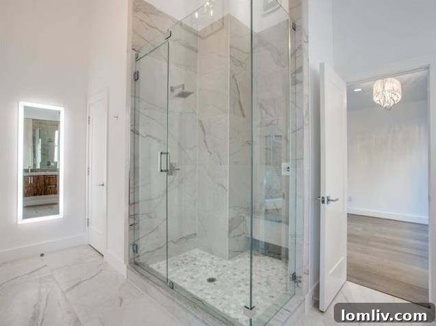 Spacious walk-in shower with high-end fixtures in the master bathroom