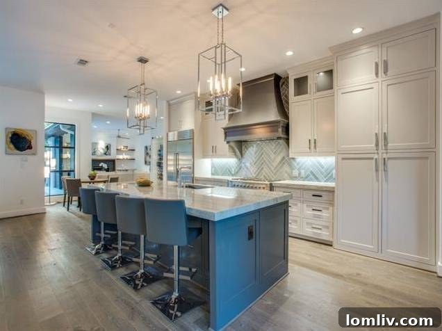 Expansive modern kitchen island with seating and designer pendant lighting