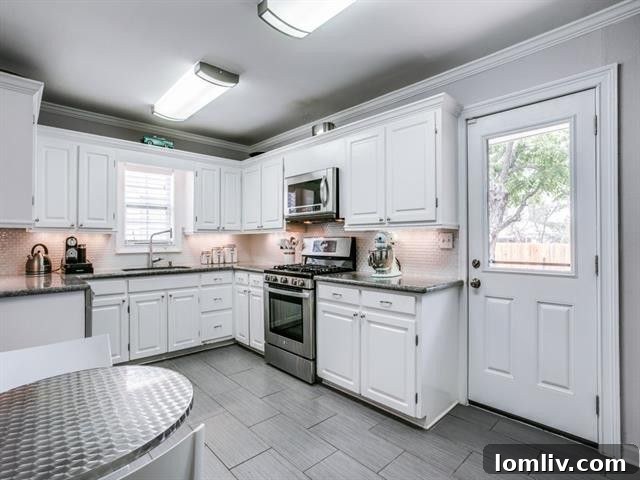 Newly updated kitchen with white cabinets, granite, and stainless steel appliances