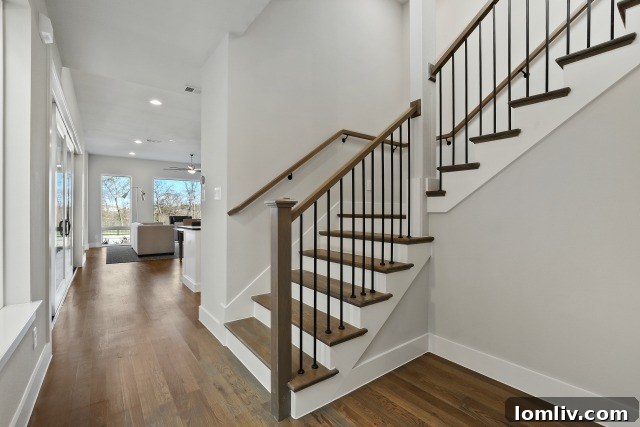 White oak handrail and iron posts on stairs in Residences at CityLine for a sleek look