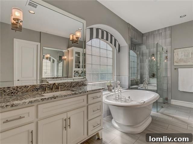 Spacious master bathroom with double vanity and luxurious finishes.