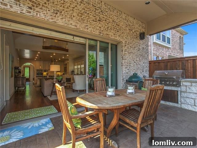 Charming outdoor patio with a pergola and custom built-in grill, surrounded by lush flowerbeds.