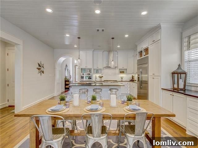 Open concept living room with high ceilings, exposed beams, and a cozy fireplace, ideal for entertaining.