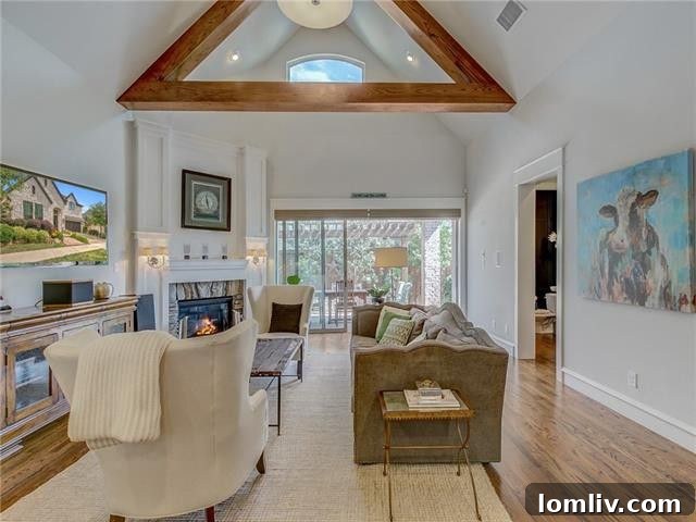 Spacious living room with high ceilings, large windows, and an inviting fireplace, perfect for family gatherings.