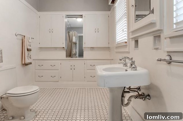 Priced Right and Ready on Windsor Place 13 Beautifully preserved vintage 1920s bathroom with white tiles and classic cabinetry