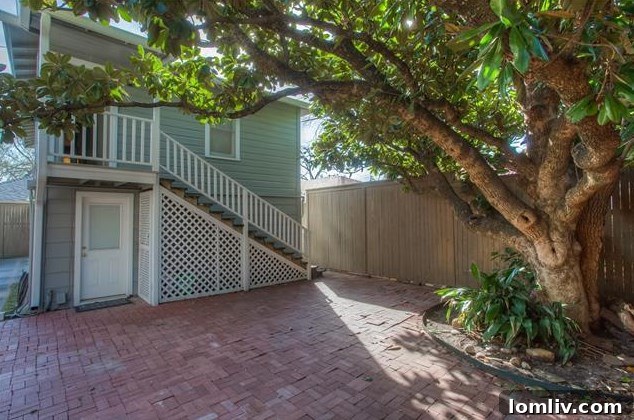 Priced Right and Ready on Windsor Place 15 Inviting backyard with a raised deck and elegant brick hardscape