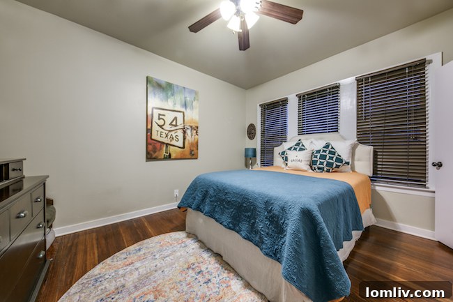 Spacious master bedroom with rich hardwood floors in a Dallas historic home