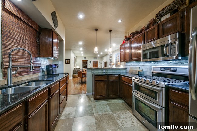 Modern kitchen with cherry wood cabinets and stainless steel appliances