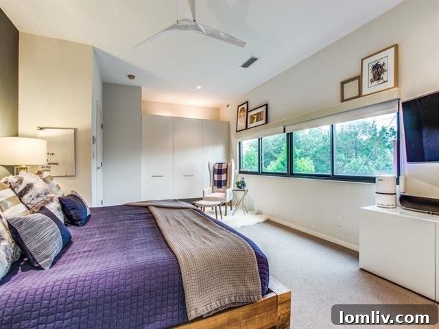 Contemporary ceiling fan and ample space in the luxurious master suite.