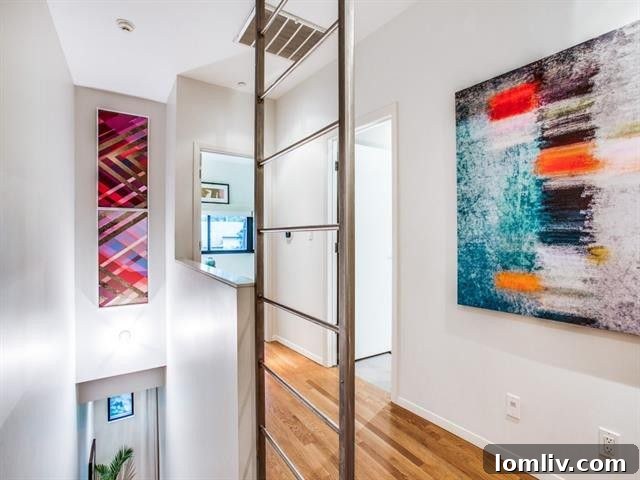 The third-floor landing with a custom stair rail and abundant natural light, ideal for showcasing art.