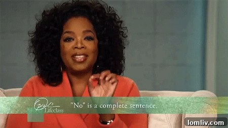 Elegant living area inside the Madroneagle Estate with a stone fireplace, high ceilings, and panoramic windows.