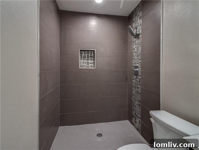 Third bedroom with consistent laminate flooring and contemporary design