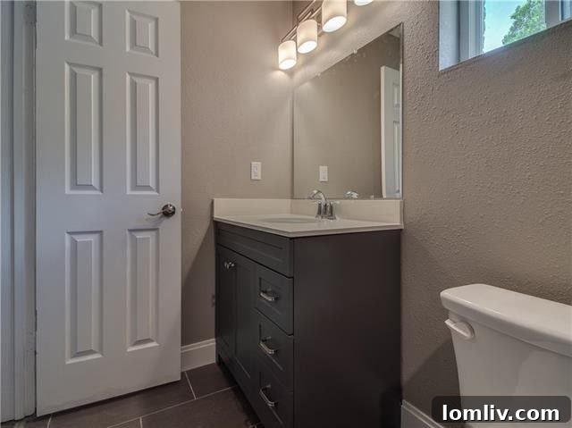 Updated master bathroom with modern tile and vanity
