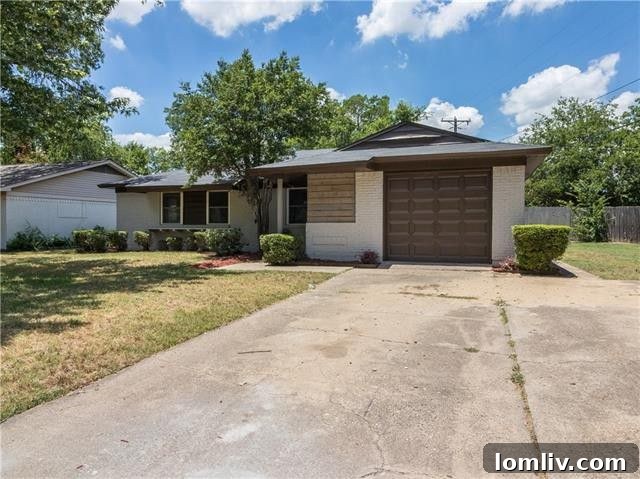 Close-up of the modern garage door and painted brick exterior at 12227 Brisbane Ave