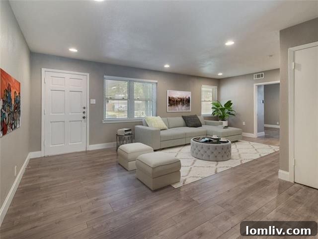 Modern kitchen with white cabinets, dark quartz countertops, and stainless steel appliances