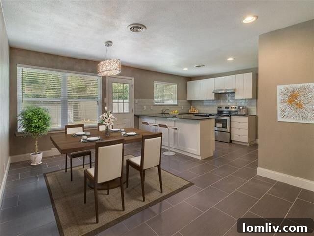 Kitchen island/breakfast bar with sleek white cabinets and contemporary design