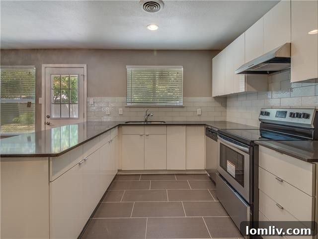 Dining area adjacent to the kitchen, featuring a stylish chandelier and ample light