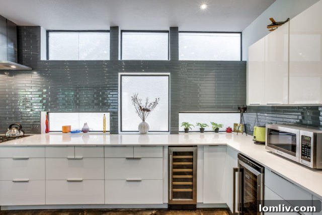 View from the living room towards the kitchen, highlighting the concrete floors and natural light