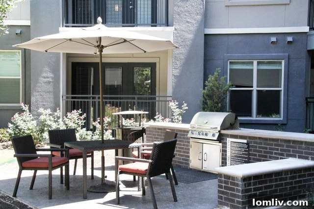 Axis at Wycliff's inviting outdoor patio with a modern grill