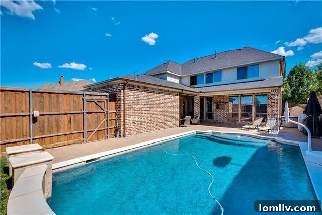 Sparkling private swimming pool with a covered patio in the backyard of 4518 Siena Drive Frisco