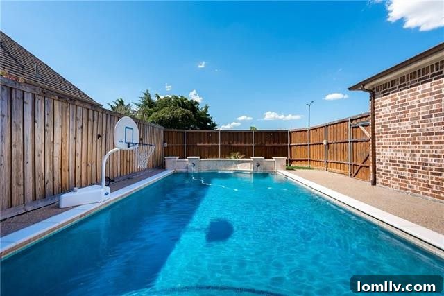 Welcoming entrance of 4518 Siena Drive Frisco, showcasing lush landscaping and vibrant greenery