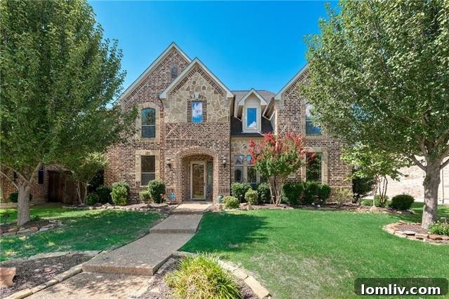 Front view of 4518 Siena Drive Frisco, highlighting its impressive brick and stone architecture with a three-car garage