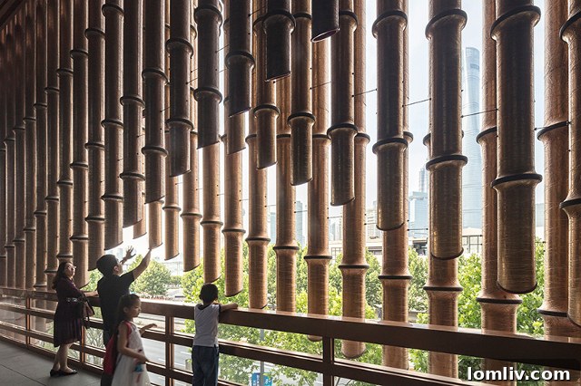 The Bund Financial Center Cultural Center with its moving curtain fully open, revealing an outdoor space behind.