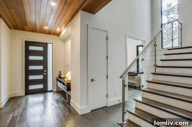 Elegant powder bath with modern fixtures next to a contemporary staircase