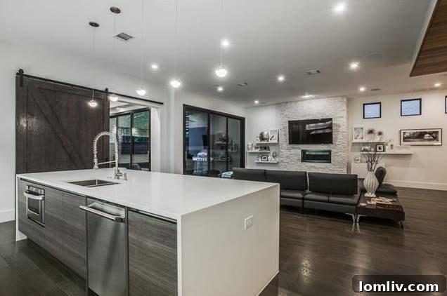 Uncluttered modern kitchen with SubZero refrigerator/freezer cleverly hidden in the pantry