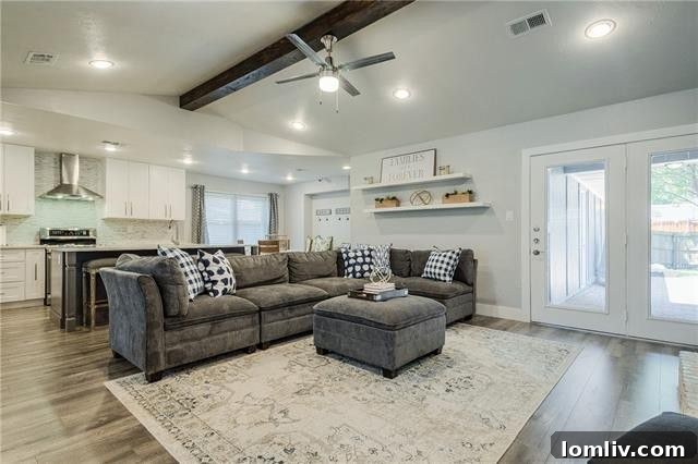 Spacious open-concept living area with laminate wood floors and a cozy fireplace