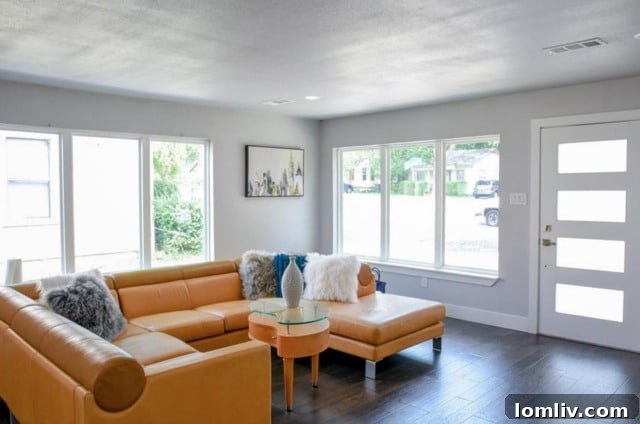 Bright open-concept living room with hardwood floors and recessed lighting