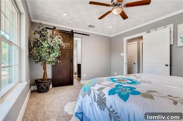 Luxurious master bedroom featuring elegant sliding barn doors