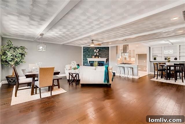 Living room with a large painted fireplace and elegant hardwood floors