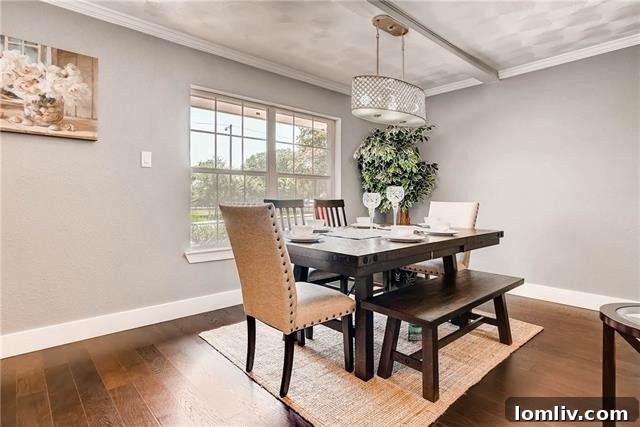 Modern kitchen with breakfast bar, white shaker cabinets, and stainless steel appliances
