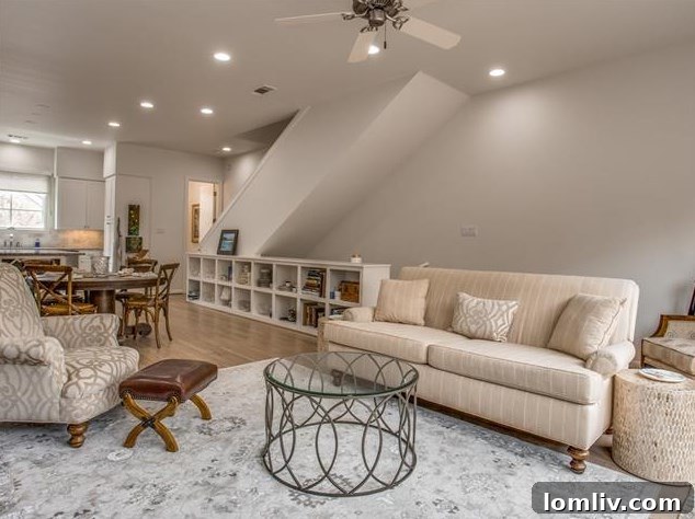 Arch Adams Townhouse: Modern Elegance, Prime Address 7 Spacious open-concept living room with a fireplace and balcony