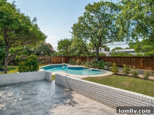 Splurge vs Steal: Sophisticated Living in Northwest Dallas 12 Private backyard with swimming pool and new deck, perfect for entertaining.