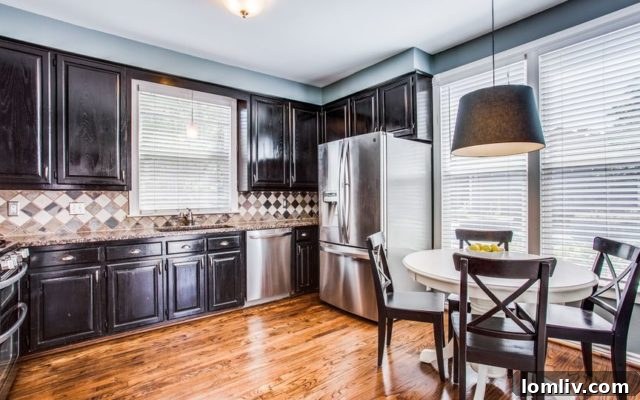 The vibrant blue Craftsman home at 5538 Junius St, a blend of historic charm and modern comfort in Junius Heights.