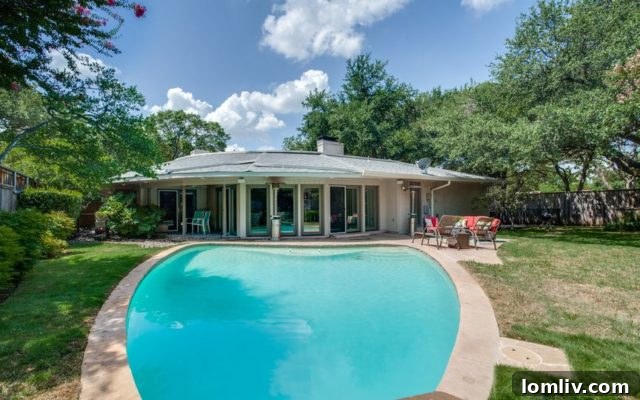 Inviting backyard with a sparkling pool at 6815 Prestonshire Lane, perfect for outdoor family fun.