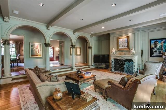 Bluffview's Private 2-Acre Urban Sanctuary 13 The great room featuring a grand beamed ceiling, fireplace, elegant arched doorways, and Corinthian columns